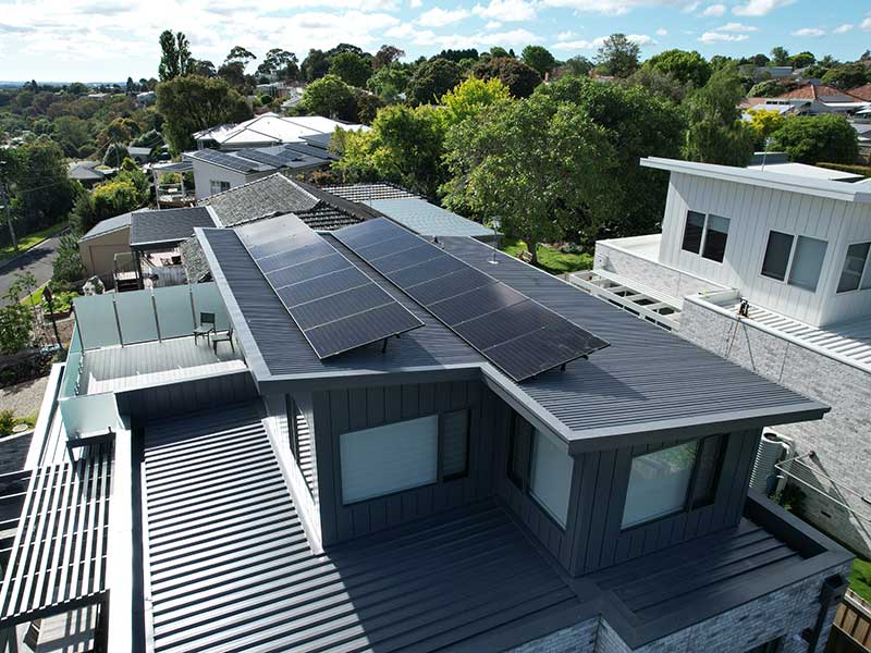 Residential property with dark roof and solar panels