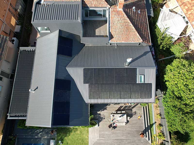 Aerial view of residential property with solar panels