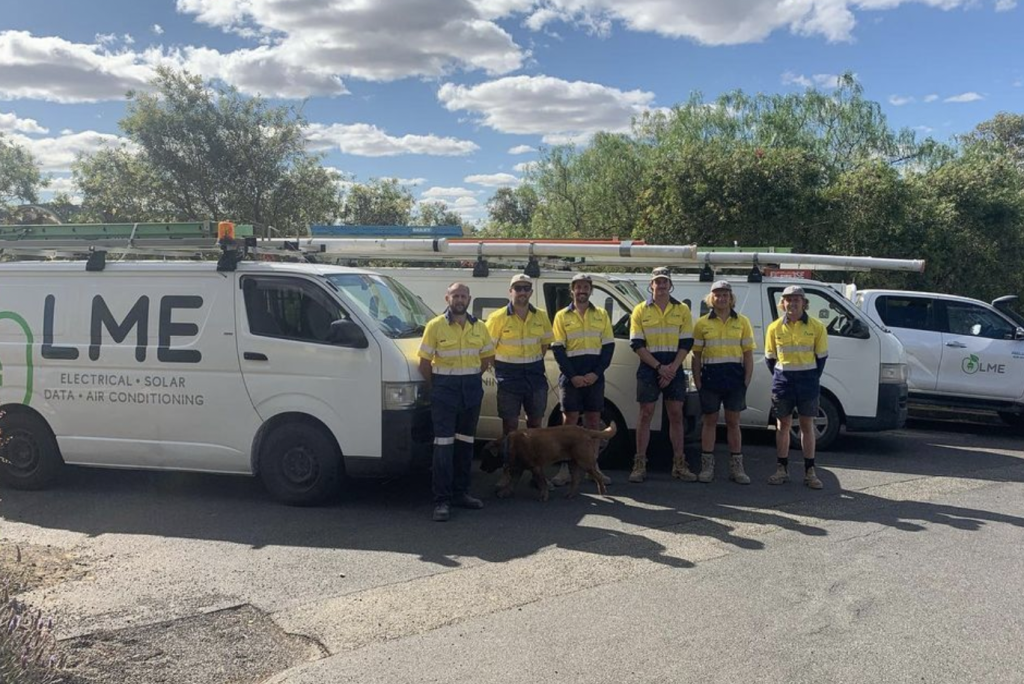 Luke Mitchell Electrical team standing next to their work vehicles